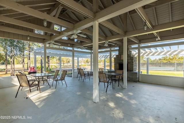 unfurnished sunroom with lofted ceiling and ceiling fan