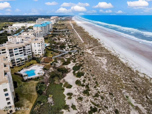 birds eye view of property with a view of the beach and a water view