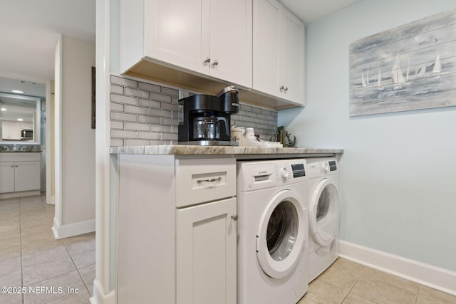 clothes washing area featuring light tile patterned floors and washing machine and clothes dryer