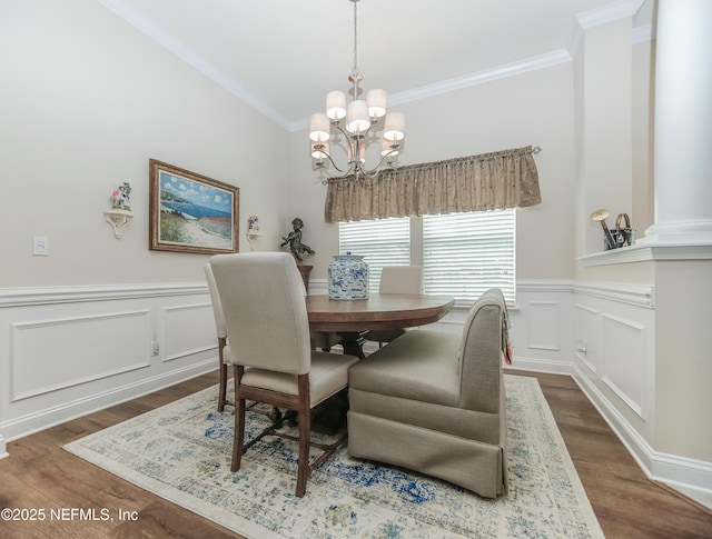 dining area featuring dark hardwood / wood-style flooring, a notable chandelier, and ornamental molding