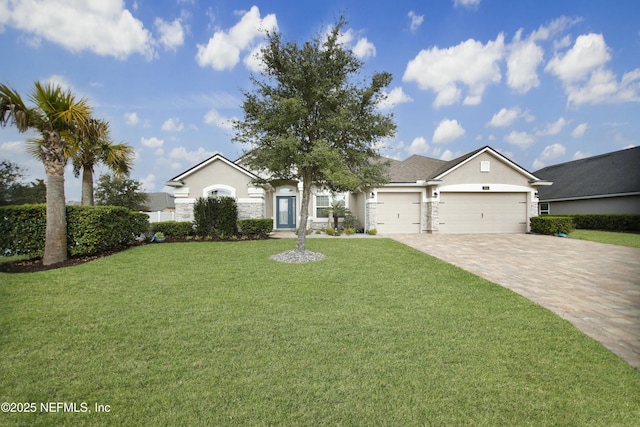 ranch-style home featuring a garage and a front lawn