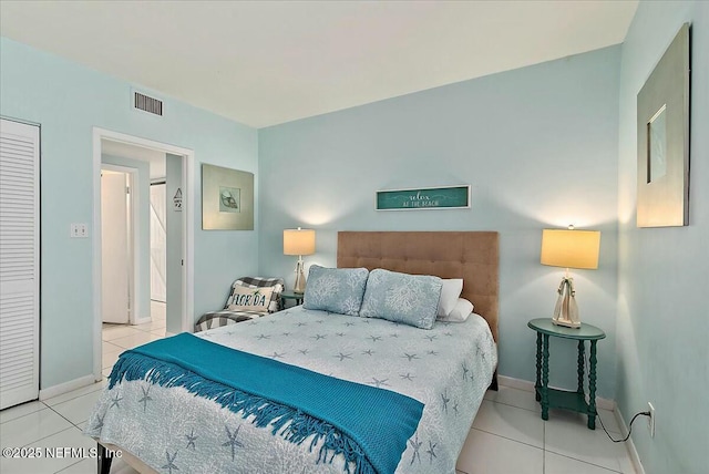 bedroom with light tile patterned floors