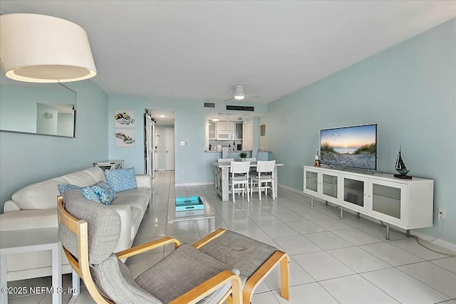 tiled living room featuring ceiling fan