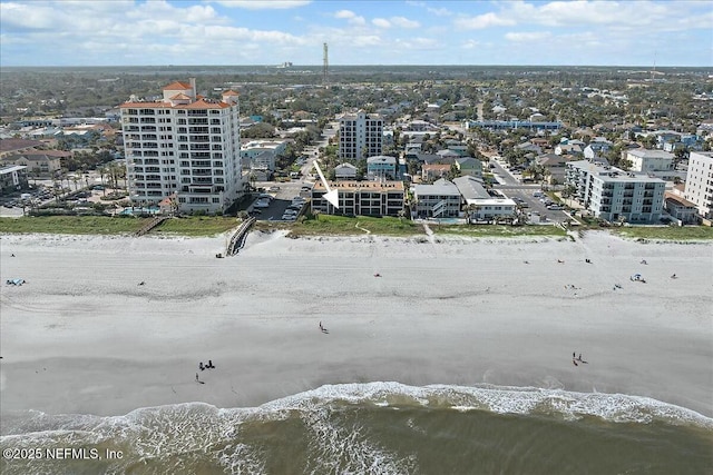 drone / aerial view featuring a water view and a beach view