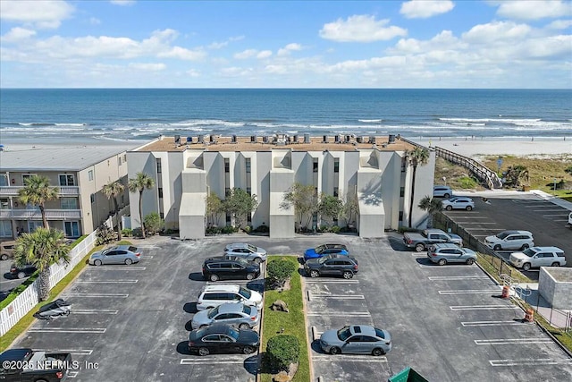 bird's eye view with a water view and a beach view