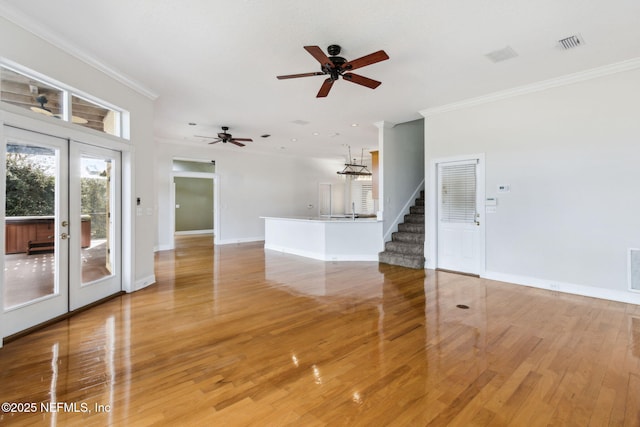 unfurnished room featuring ornamental molding, hardwood / wood-style floors, and french doors