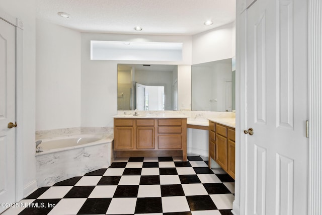 bathroom featuring vanity, separate shower and tub, and a textured ceiling