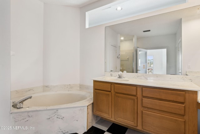 bathroom with vanity and separate shower and tub