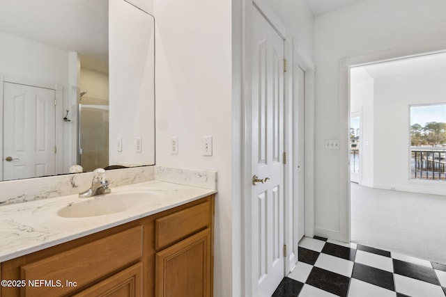 bathroom with vanity and a shower with door