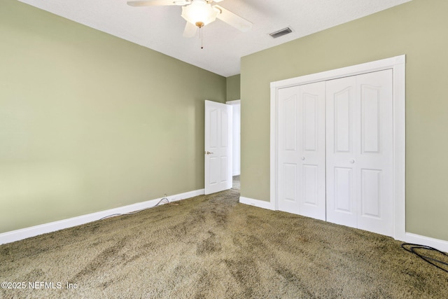 unfurnished bedroom featuring a closet, ceiling fan, and carpet