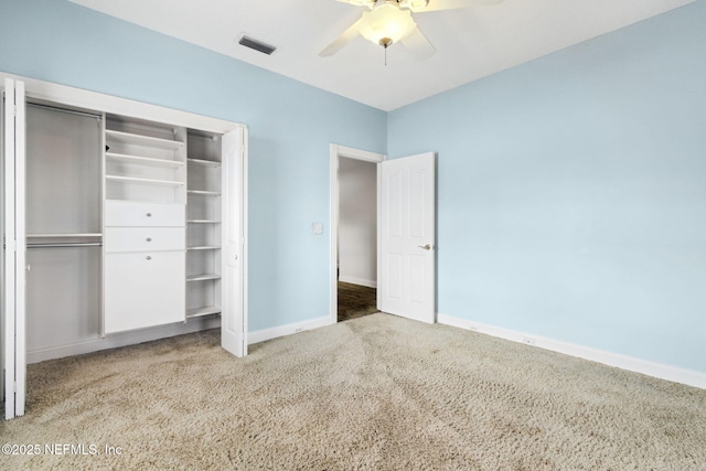 unfurnished bedroom with carpet floors, ceiling fan, and a closet