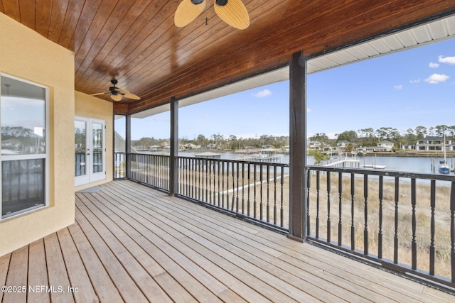 deck featuring a water view, ceiling fan, and french doors