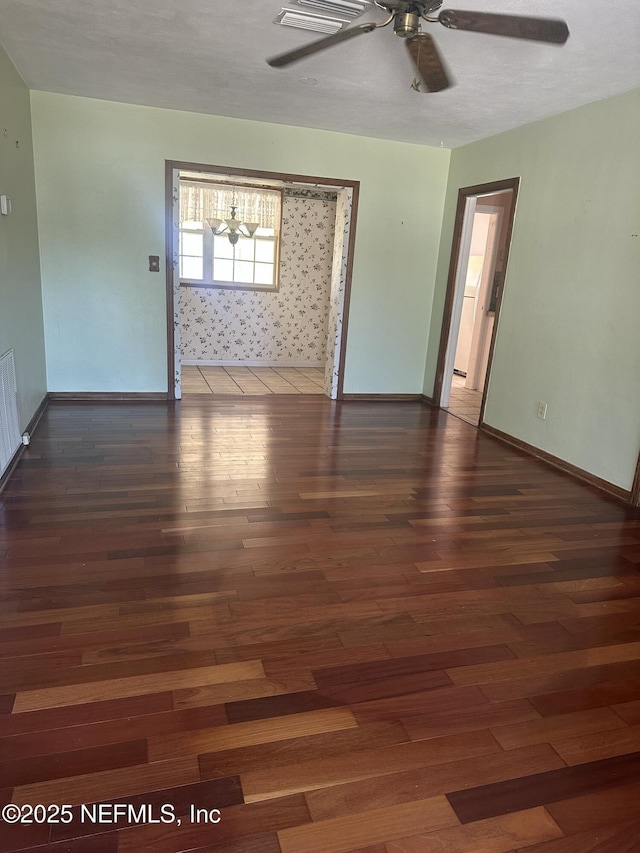 spare room with dark hardwood / wood-style floors and ceiling fan