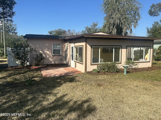 back of house featuring a yard and a patio