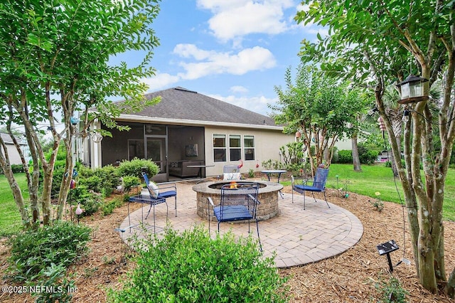 view of patio / terrace featuring a sunroom and a fire pit