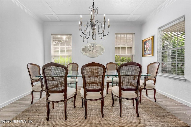 dining room featuring an inviting chandelier, wood-type flooring, and ornamental molding