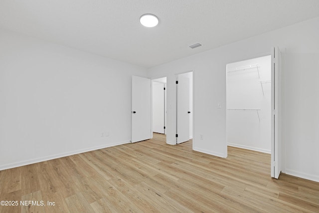 unfurnished room with light hardwood / wood-style floors