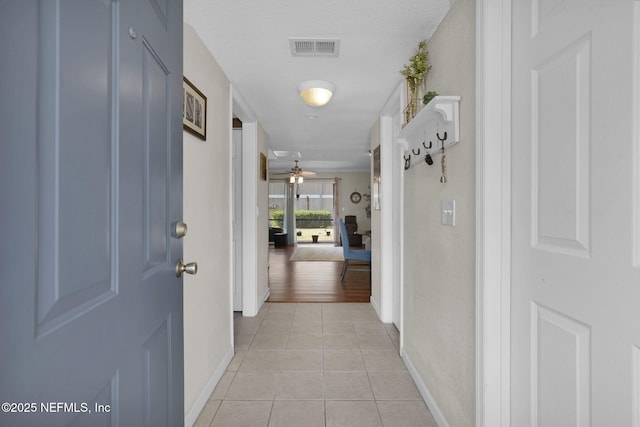 hall with light tile patterned flooring