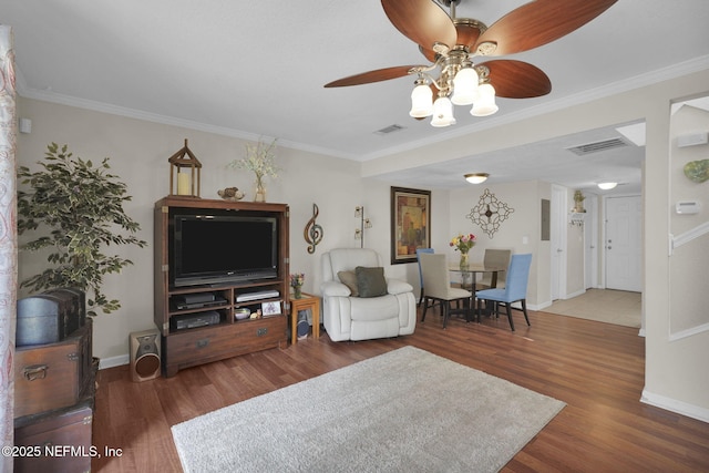 living room featuring dark wood-type flooring, ceiling fan, and ornamental molding