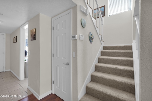 staircase featuring tile patterned flooring