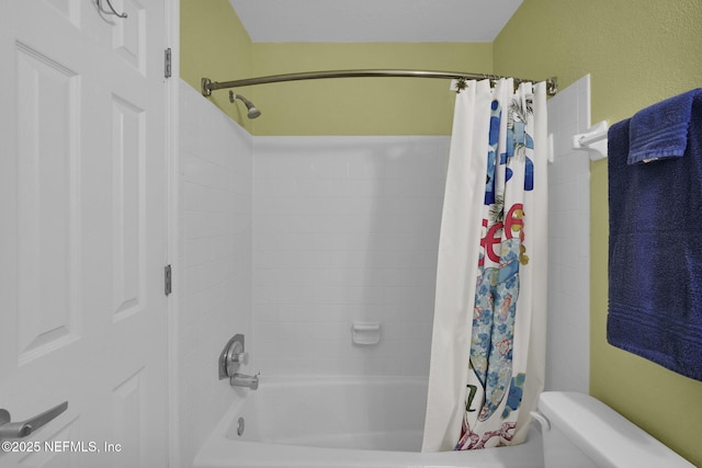 bathroom featuring shower / bathtub combination with curtain and toilet