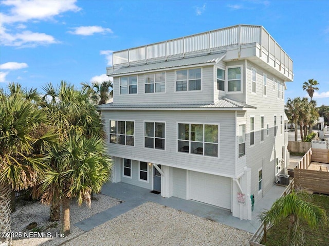 view of front facade with a garage and central AC