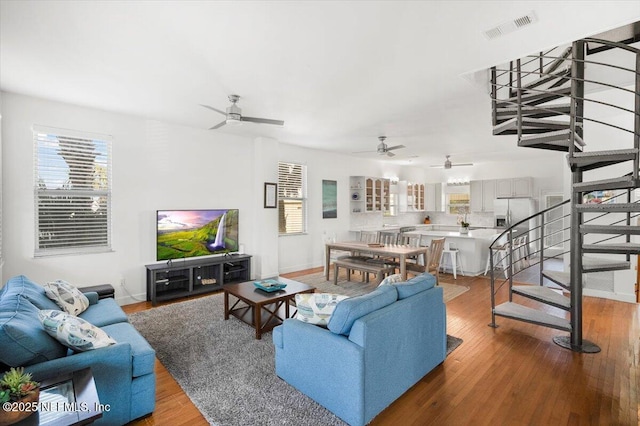 living room with hardwood / wood-style flooring and ceiling fan