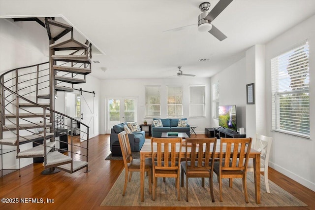 dining area with wood-type flooring and ceiling fan