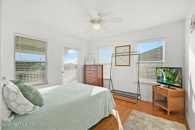 bedroom featuring ceiling fan, access to exterior, and light wood-type flooring