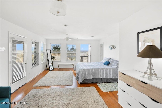 bedroom with ceiling fan, access to exterior, and light hardwood / wood-style floors