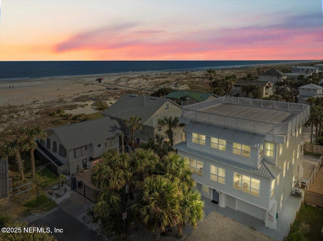 aerial view at dusk with a water view