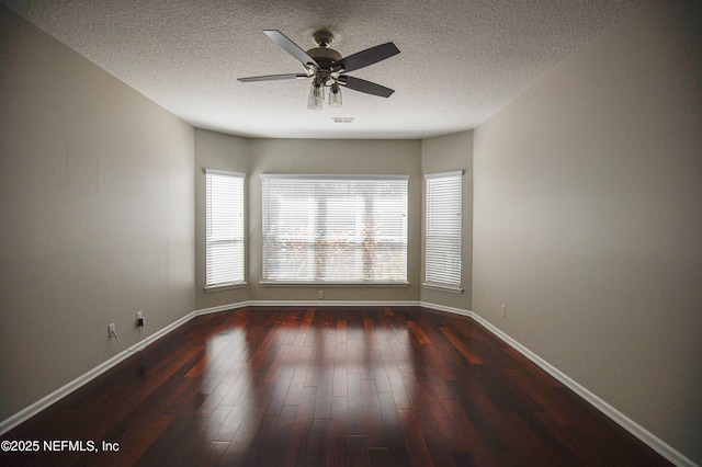 spare room with ceiling fan, a textured ceiling, and dark hardwood / wood-style flooring