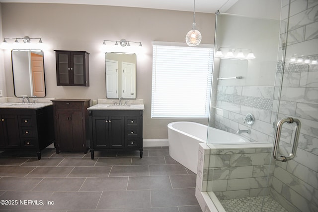 bathroom with tile patterned flooring, shower with separate bathtub, and vanity