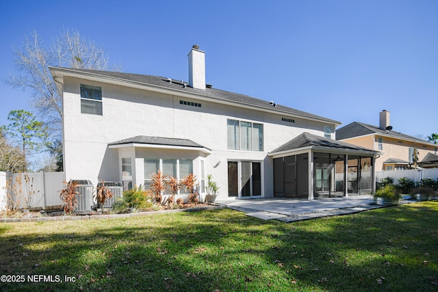 rear view of house with central AC, a yard, a patio area, and a sunroom