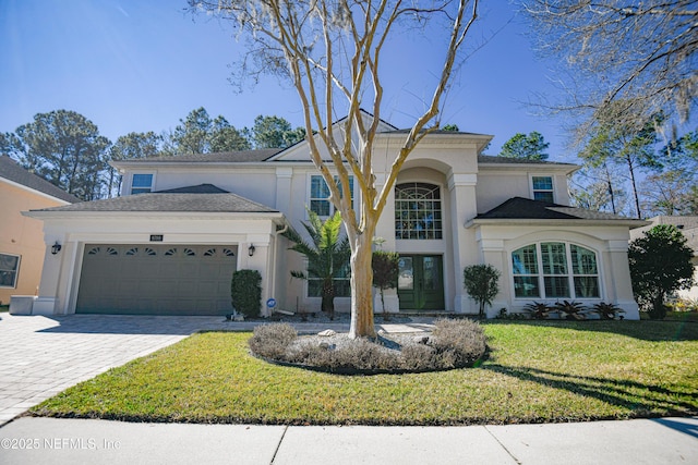 view of front of house with a garage and a front lawn