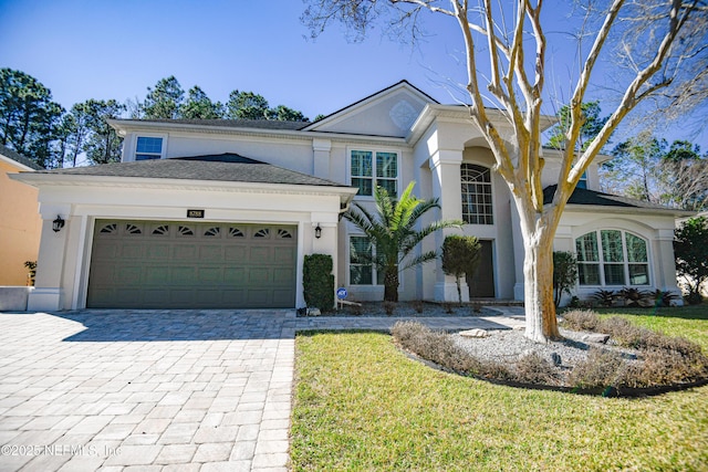 view of front facade with a garage and a front yard