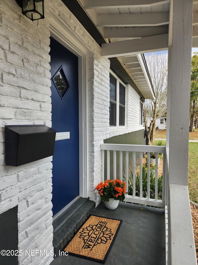 view of exterior entry with covered porch