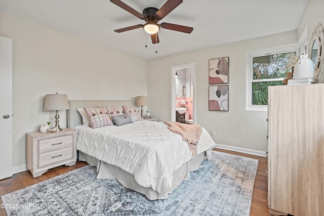 bedroom featuring hardwood / wood-style flooring, connected bathroom, and ceiling fan