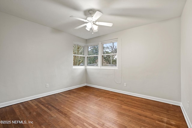 spare room with hardwood / wood-style flooring and ceiling fan