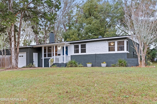 single story home featuring a garage and a front lawn