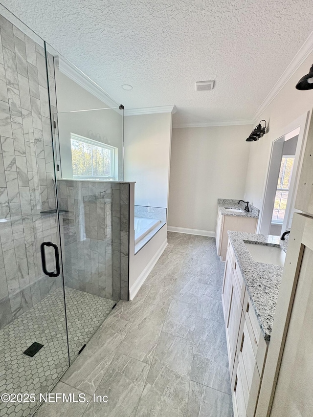 bathroom with a stall shower, ornamental molding, baseboards, a bath, and vanity