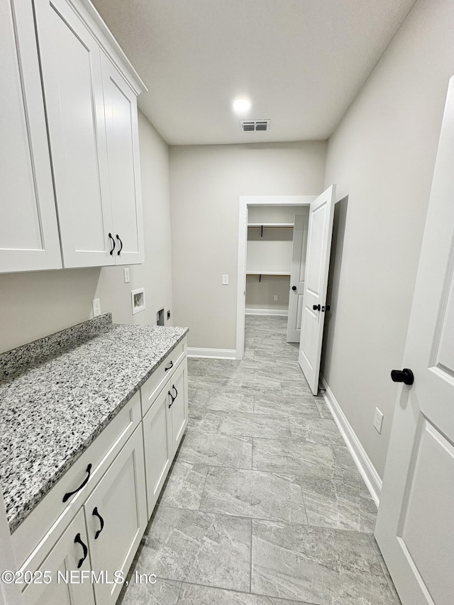 6141 Charlie Rowe Dr, Macclenny, FL 32063 - laundry area featuring baseboards, visible vents, cabinet space, electric dryer hookup, and washer hookup