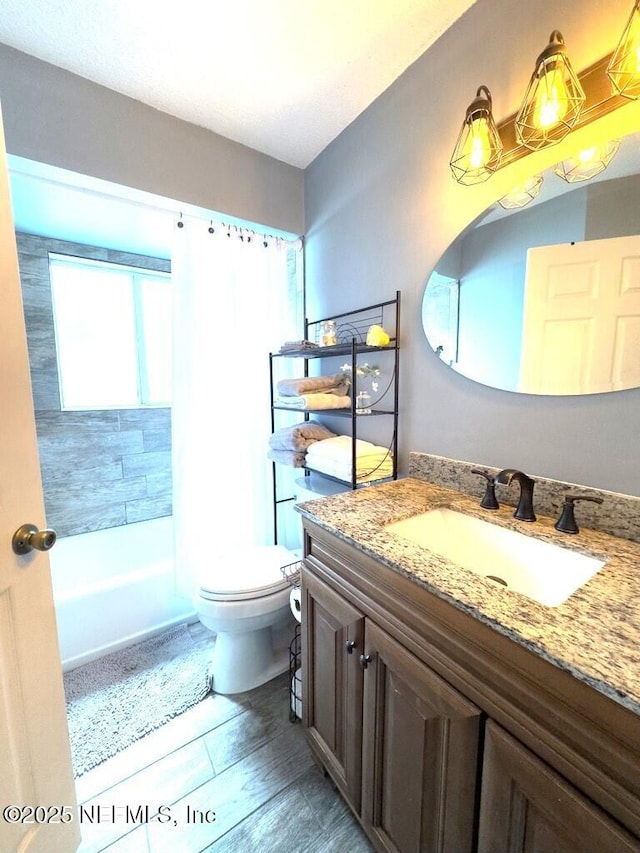 full bathroom featuring hardwood / wood-style flooring, vanity, tiled shower / bath, and toilet