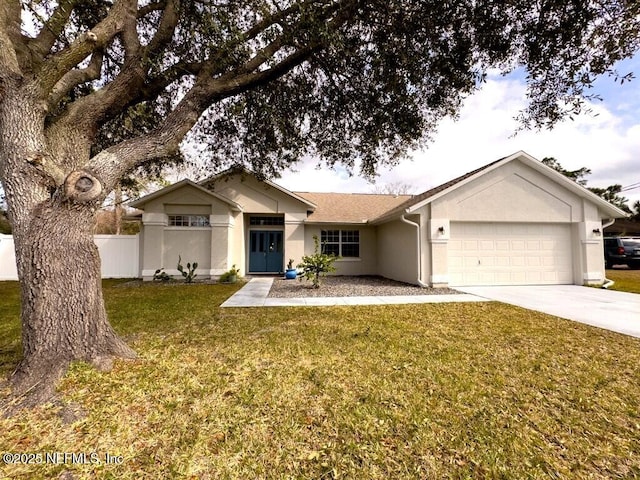 single story home with a garage and a front lawn