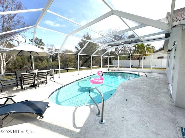 view of pool featuring a patio and glass enclosure