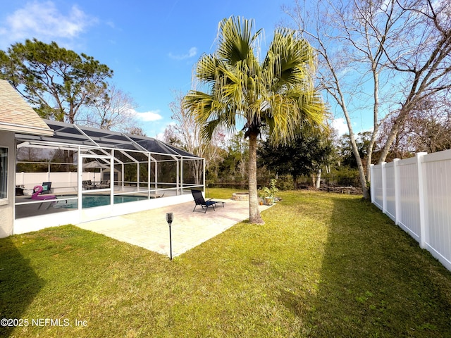 view of yard with a lanai, a fenced in pool, and a patio