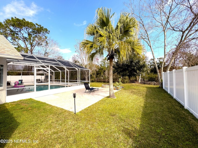 view of yard featuring a patio, a fenced in pool, and glass enclosure