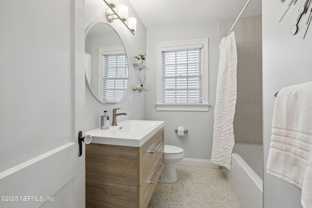 bathroom with tile patterned flooring, toilet, shower / tub combo, vanity, and baseboards