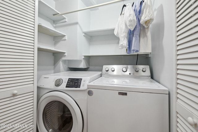 washroom featuring laundry area and washing machine and clothes dryer