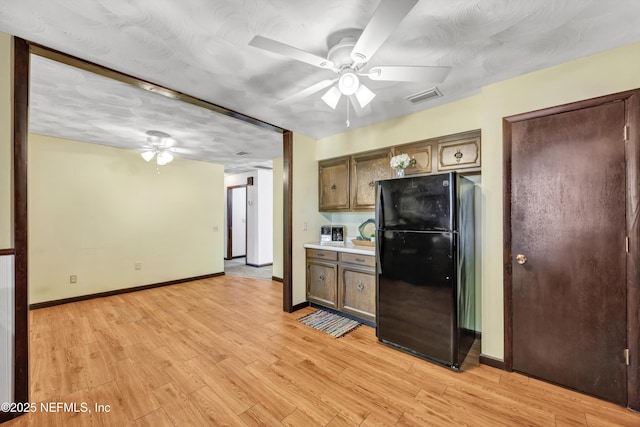 1019 Haynes Ct, Green Cove Springs, FL 32043 - kitchen featuring black refrigerator, ceiling fan, light hardwood / wood-style floors, and a textured ceiling
